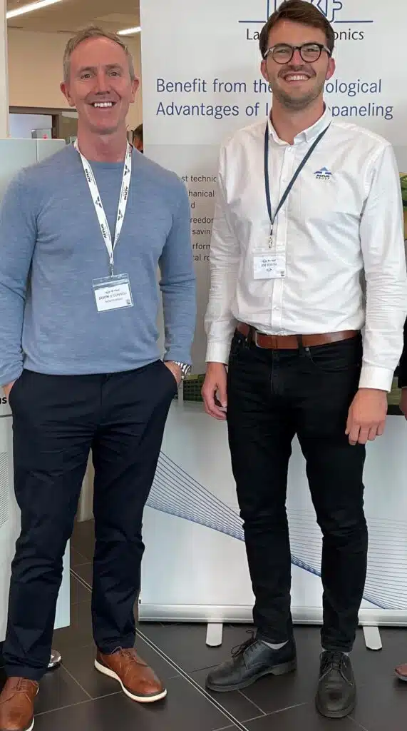 Two men smiling at a professional event